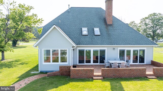 1702 Ferry Point Ct, Trappe, MD 21673 - rear view of property featuring a chimney, a lawn, and a patio
