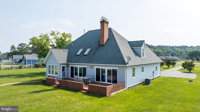 1702 Ferry Point Ct, Trappe, MD 21673 - back of property featuring a yard, central AC, a shingled roof, a chimney, and a patio