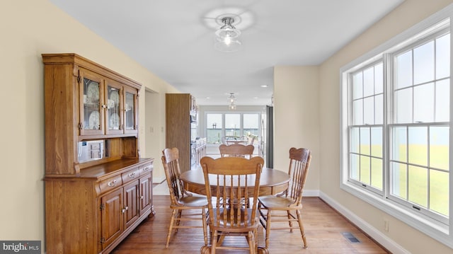 1702 Ferry Point Ct, Trappe, MD 21673 - dining area featuring light wood-type flooring, plenty of natural light, and baseboards