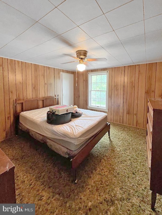 873 Maple St, Lanse, PA 16849 - carpeted bedroom with wood walls and ceiling fan