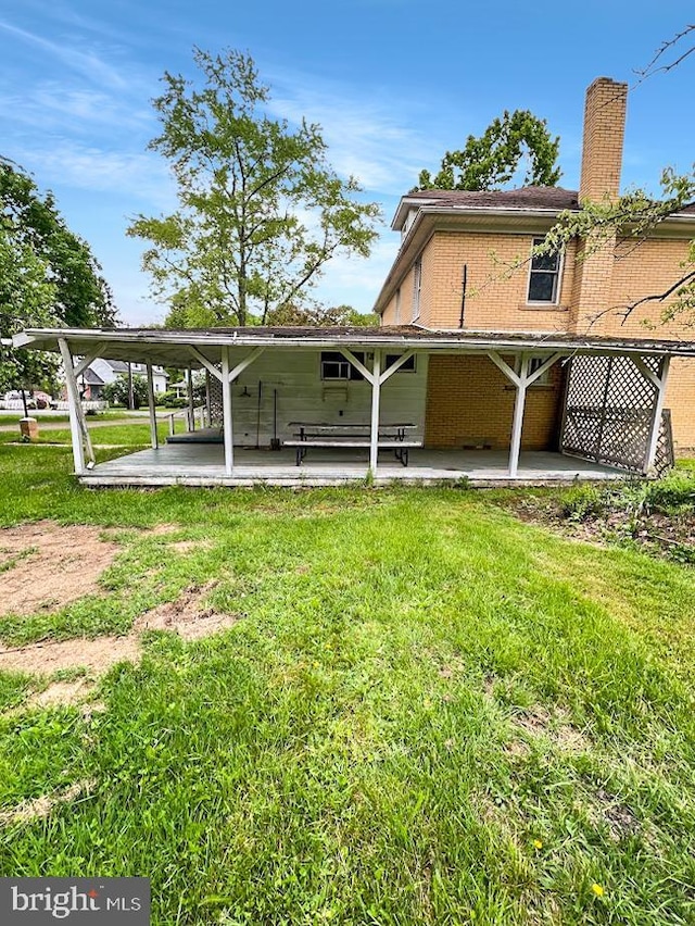 873 Maple St, Lanse, PA 16849 - rear view of property with a patio area, a yard, a chimney, and brick siding