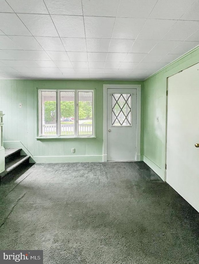873 Maple St, Lanse, PA 16849 - unfurnished living room with carpet floors, plenty of natural light, a drop ceiling, stairs, and baseboards