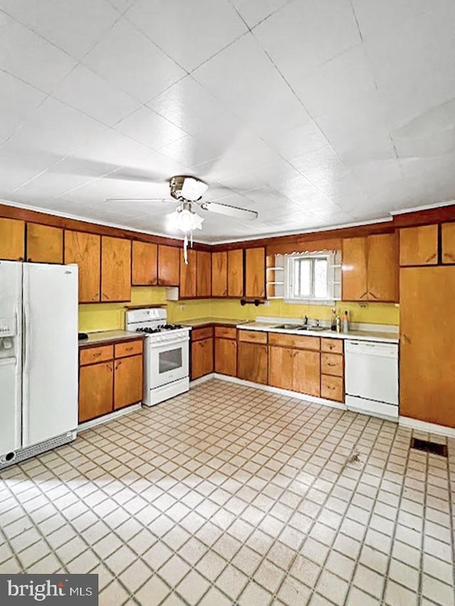873 Maple St, Lanse, PA 16849 - kitchen featuring white appliances, a sink, light countertops, brown cabinets, and ceiling fan