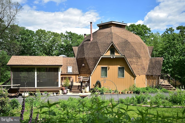 4027 Trego Mountain Rd, Keedysville, MD 21756 - rear view of house featuring a sunroom, a deck, a shingled roof, and a chimney