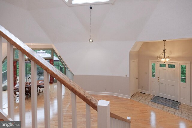 4027 Trego Mountain Rd, Keedysville, MD 21756 - foyer entrance featuring light wood-type flooring, a chandelier, baseboards, and high vaulted ceiling