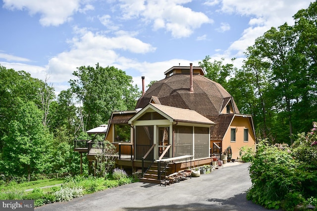 4027 Trego Mountain Rd, Keedysville, MD 21756 - view of front facade featuring a sunroom, a deck, and roof with shingles