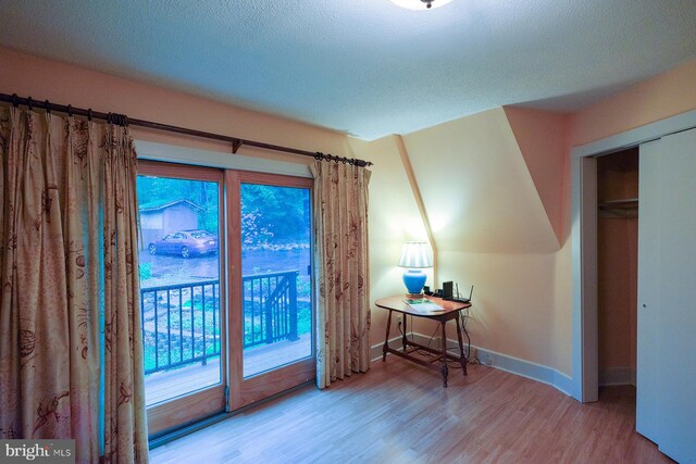 4027 Trego Mountain Rd, Keedysville, MD 21756 - bedroom with access to exterior, wood finished floors, baseboards, and a textured ceiling