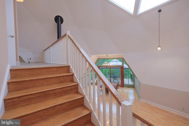 4027 Trego Mountain Rd, Keedysville, MD 21756 - stairway with a chandelier, high vaulted ceiling, baseboards, and wood finished floors