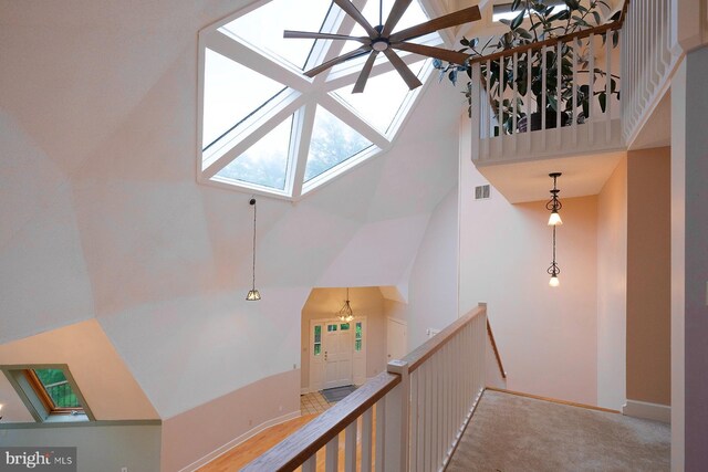 4027 Trego Mountain Rd, Keedysville, MD 21756 - stairway with high vaulted ceiling, a skylight, baseboards, carpet floors, and a ceiling fan