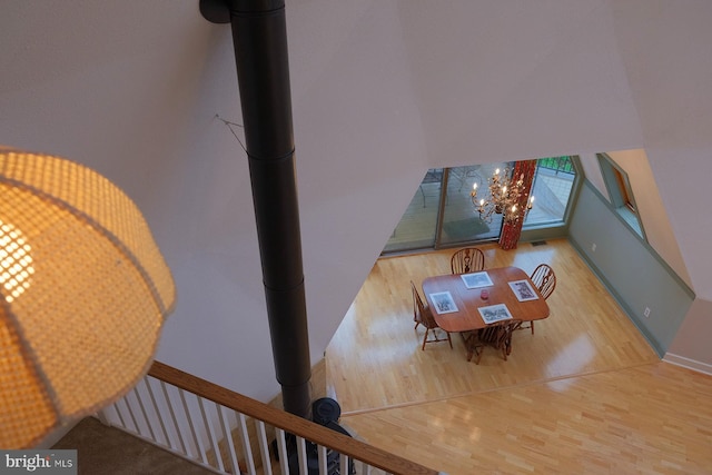 4027 Trego Mountain Rd, Keedysville, MD 21756 - dining room featuring wood finished floors, a chandelier, a towering ceiling, and baseboards