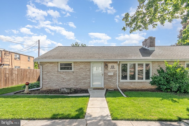 230 N Harrison St, Palmyra, PA 17078 - view of front of house with brick siding, a chimney, and roof with shingles