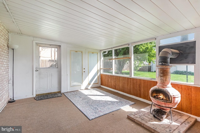 230 N Harrison St, Palmyra, PA 17078 - unfurnished sunroom with healthy amount of natural light, brick wall, carpet flooring, and wooden walls