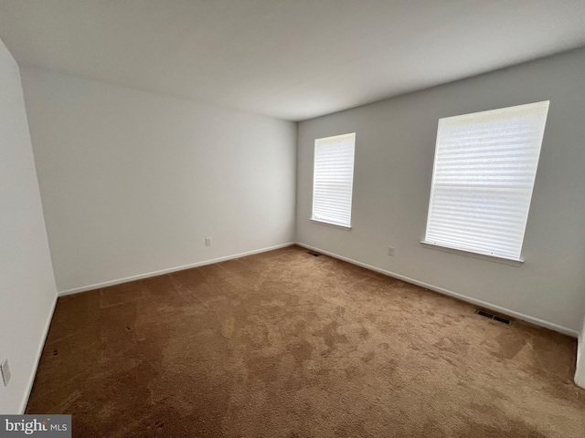 carpeted spare room with baseboards