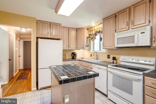 5518 Kempton Dr, Springfield, VA 22151 - kitchen with white appliances, light brown cabinets, a sink, tile counters, and a center island