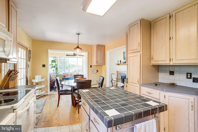 5518 Kempton Dr, Springfield, VA 22151 - kitchen featuring tile countertops, light brown cabinetry, wood finished floors, and decorative backsplash