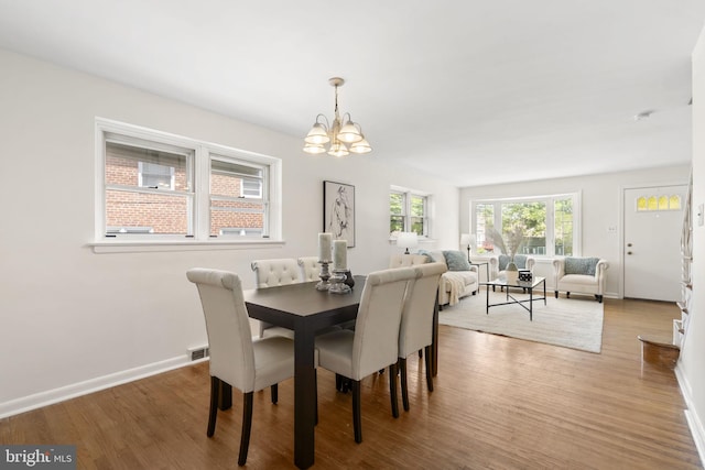 4022 Evans Ln, Drexel Hill, PA 19026 - dining space featuring a chandelier, wood finished floors, and baseboards