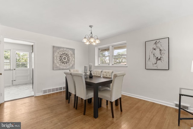 4022 Evans Ln, Drexel Hill, PA 19026 - dining room featuring a chandelier, light wood-style flooring, and baseboards