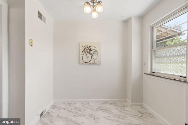 4022 Evans Ln, Drexel Hill, PA 19026 - empty room with marble look tiles, a chandelier, and baseboards