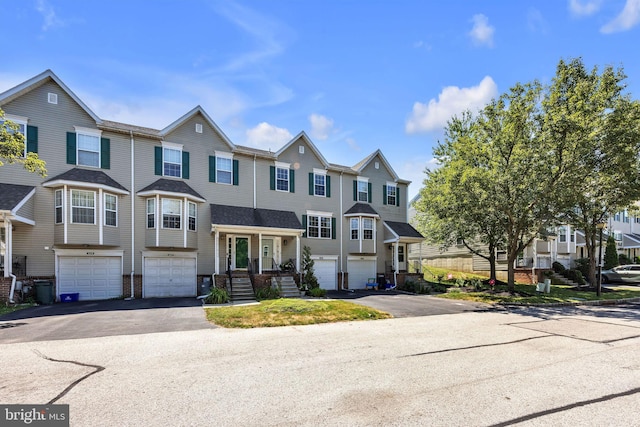 515 Williamsburg Way, King Of Prussia, PA 19406 - townhome / multi-family property featuring driveway, a residential view, an attached garage, and brick siding