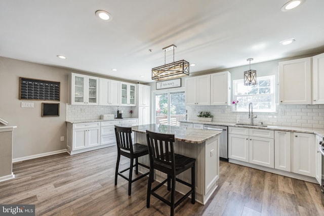 515 Williamsburg Way, King Of Prussia, PA 19406 - kitchen featuring stainless steel dishwasher, a sink, backsplash, white cabinetry, and light stone counters