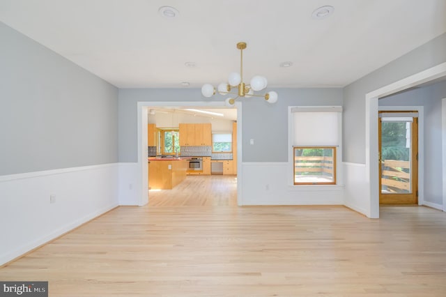 1104 Milroy Ct, Winchester, VA 22601 - unfurnished living room with light wood-style flooring and a chandelier