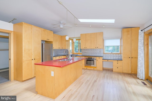 1104 Milroy Ct, Winchester, VA 22601 - kitchen with appliances with stainless steel finishes, light wood finished floors, backsplash, lofted ceiling, and light brown cabinets