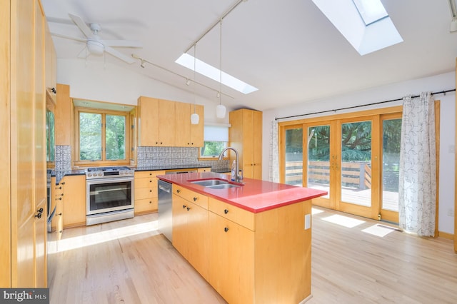 1104 Milroy Ct, Winchester, VA 22601 - kitchen with stainless steel appliances, a skylight, lofted ceiling, light wood finished floors, and backsplash