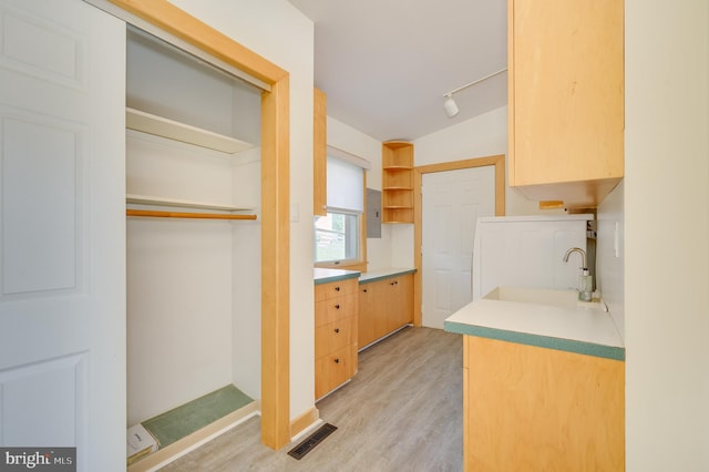 1104 Milroy Ct, Winchester, VA 22601 - kitchen featuring open shelves, light brown cabinetry, light wood-style floors, light countertops, and rail lighting