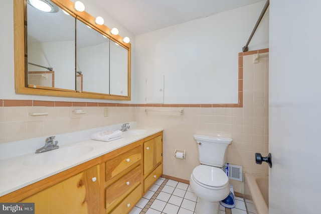1104 Milroy Ct, Winchester, VA 22601 - bathroom with double vanity, tile walls, tile patterned flooring, a wainscoted wall, and shower / washtub combination