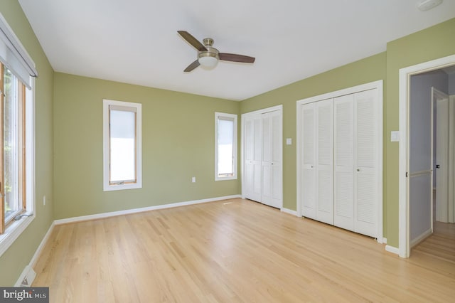 1104 Milroy Ct, Winchester, VA 22601 - unfurnished bedroom featuring multiple closets, multiple windows, and light wood finished floors
