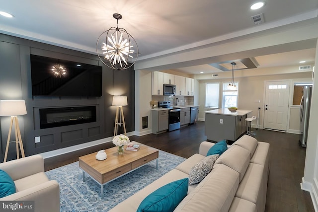 3815 Cottage Ave, Baltimore, MD 21215 - living area with a chandelier, recessed lighting, dark wood-type flooring, and baseboards