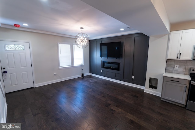 3815 Cottage Ave, Baltimore, MD 21215 - unfurnished living room featuring a chandelier, recessed lighting, baseboards, and dark wood-type flooring