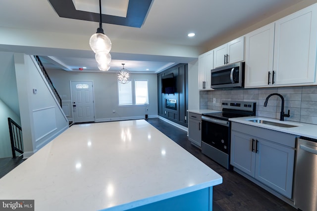 3815 Cottage Ave, Baltimore, MD 21215 - kitchen with appliances with stainless steel finishes, a sink, tasteful backsplash, white cabinets, and recessed lighting