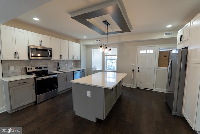 3815 Cottage Ave, Baltimore, MD 21215 - kitchen featuring stainless steel appliances, a center island, dark wood-style floors, decorative backsplash, and recessed lighting