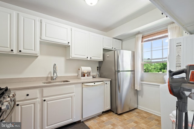 6034 Westchester Park Dr Unit 202, College Park, MD 20740 - kitchen featuring appliances with stainless steel finishes, a sink, light countertops, and white cabinets
