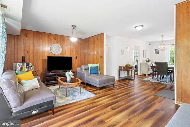 6034 Westchester Park Dr Unit 202, College Park, MD 20740 - living area featuring wooden walls, a chandelier, and wood finished floors