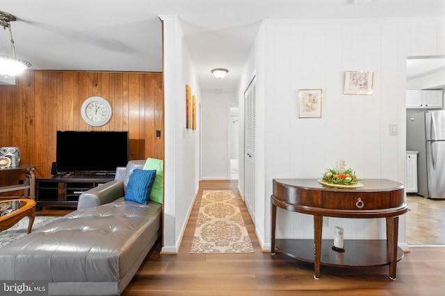 6034 Westchester Park Dr Unit 202, College Park, MD 20740 - living room with wood walls, wood finished floors, and baseboards