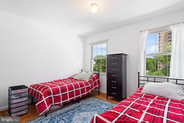 6034 Westchester Park Dr Unit 202, College Park, MD 20740 - bedroom featuring multiple windows, baseboards, and wood finished floors