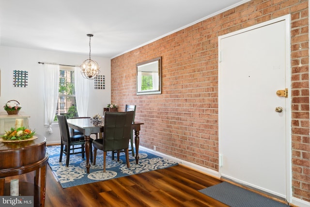 6034 Westchester Park Dr Unit 202, College Park, MD 20740 - dining room featuring brick wall, baseboards, a chandelier, and wood finished floors