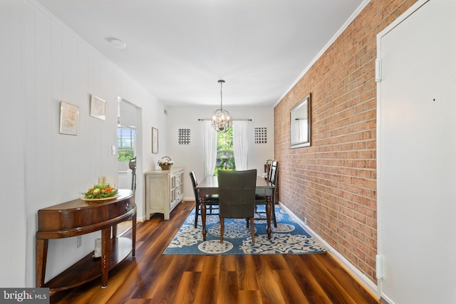 6034 Westchester Park Dr Unit 202, College Park, MD 20740 - dining area with brick wall, dark wood-style floors, and a chandelier