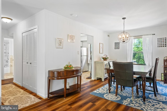 6034 Westchester Park Dr Unit 202, College Park, MD 20740 - dining room featuring a chandelier, dark wood-style flooring, and ornamental molding