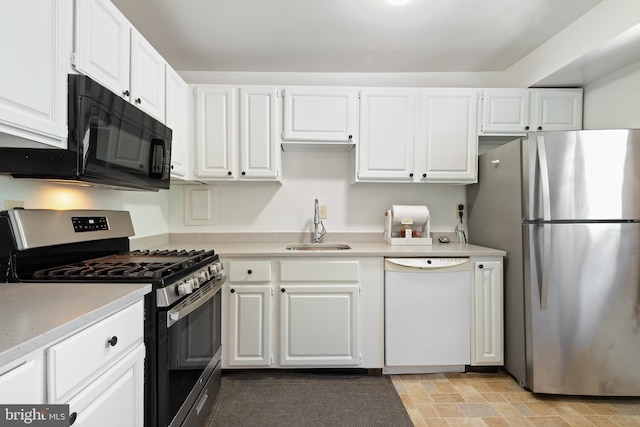 6034 Westchester Park Dr Unit 202, College Park, MD 20740 - kitchen featuring stainless steel appliances, a sink, white cabinets, and light countertops