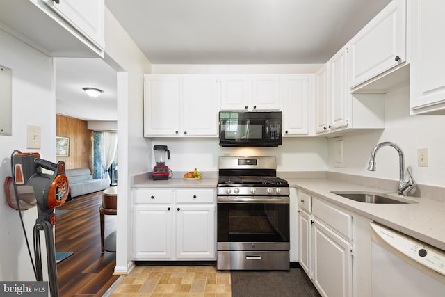 6034 Westchester Park Dr Unit 202, College Park, MD 20740 - kitchen featuring black microwave, gas stove, white dishwasher, a sink, and light countertops