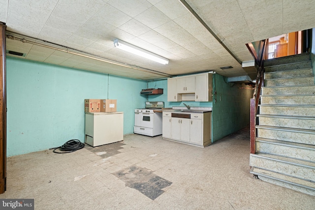 7164 Walker St, Philadelphia, PA 19135 - kitchen featuring white gas range, white cabinets, a sink, and light countertops