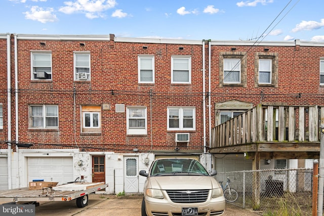 7164 Walker St, Philadelphia, PA 19135 - view of front of property featuring brick siding, an attached garage, and driveway