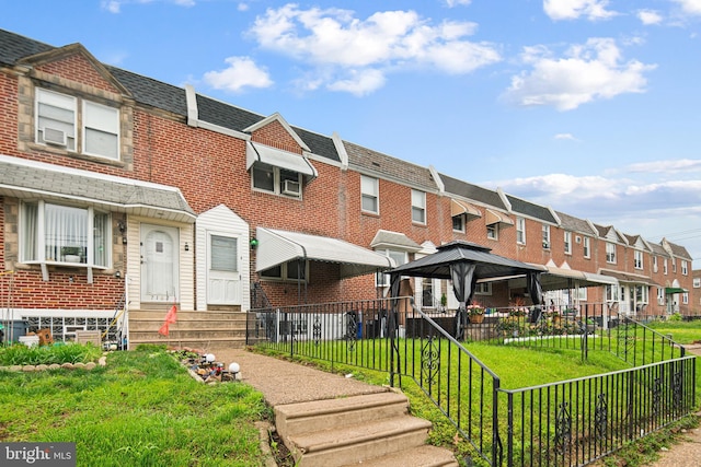 7164 Walker St, Philadelphia, PA 19135 - view of front of property featuring a gazebo, a residential view, brick siding, and entry steps