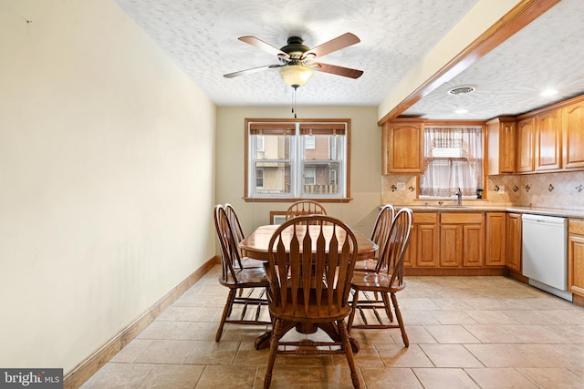 7164 Walker St, Philadelphia, PA 19135 - dining room with a ceiling fan, a textured ceiling, and baseboards
