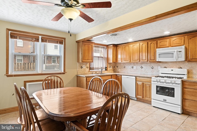 7164 Walker St, Philadelphia, PA 19135 - kitchen featuring white appliances, a sink, tasteful backsplash, light countertops, and a textured ceiling
