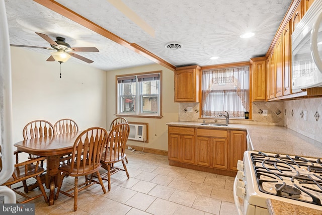 7164 Walker St, Philadelphia, PA 19135 - kitchen featuring white appliances, tasteful backsplash, light countertops, a sink, and a textured ceiling
