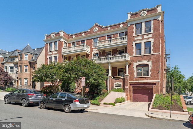 1419 Clifton St NW Unit 101, Washington, DC 20009 - view of property featuring a garage and concrete driveway